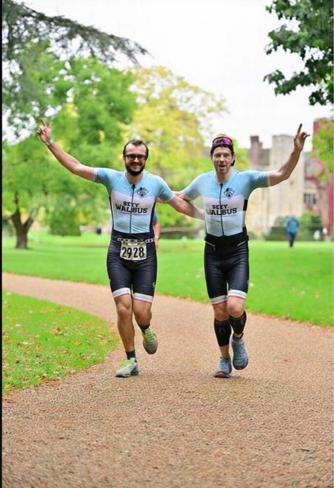 Two runners crossing a finish line together