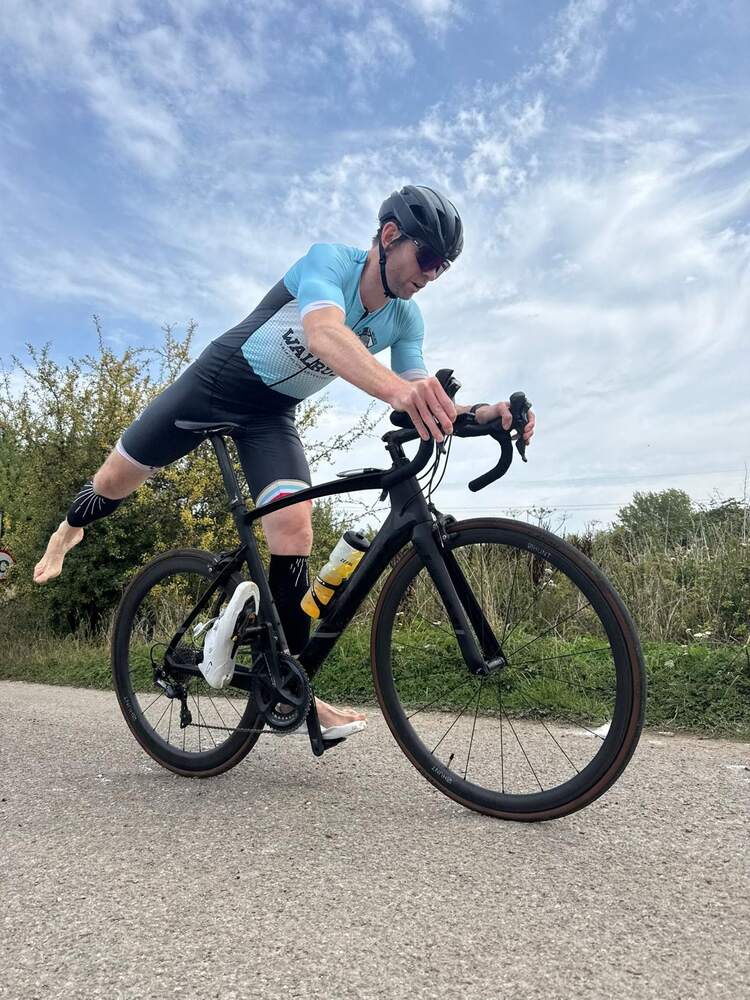 A rider out of the saddle on a road bicycle