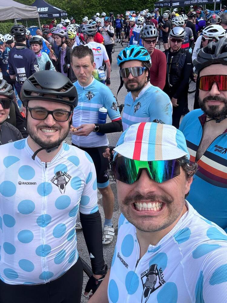A large group of members at a start line in club and other kit