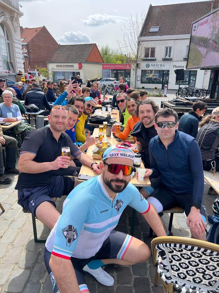 Members eating at a long table outside after the race