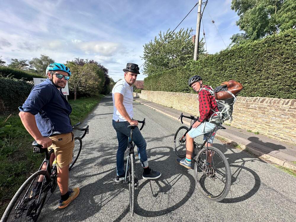 Three cyclists on a country lane