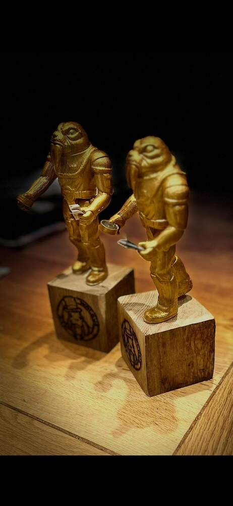 Two gold-painted walrus figures, photographed side by side