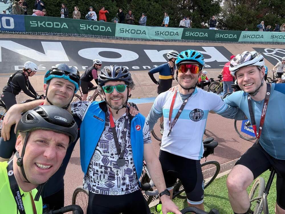Members waiting at a start line with event banners behind them
